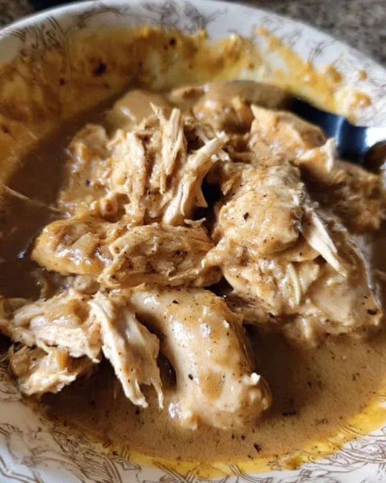 Plate of slow cooker chicken and gravy served with mashed potatoes and green beans